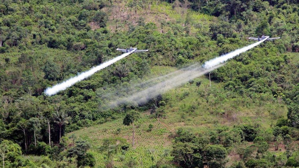 Two planes fumigate coca fields in San Miguel, on the border with Ecuador, some 400 miles south of Bogota, Colombia, on Dec.11, 2006.