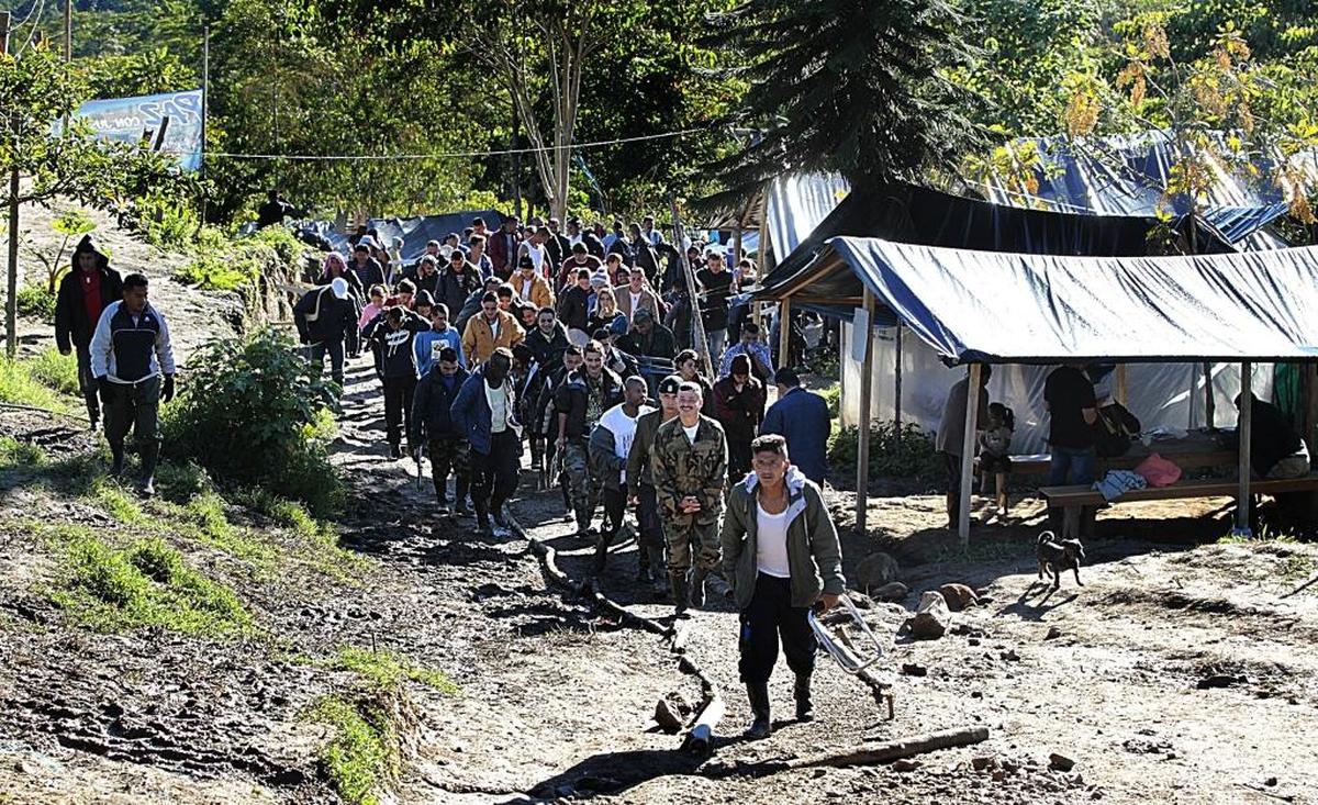 Colombia's FARC guerrillas coming out of a morning meeting at a “normalization” zone near the town of Icononzo. The camp is one of 26 where the FARC have gathered as they begin the transition to civilian life in the wake of a historic peace deal last year.