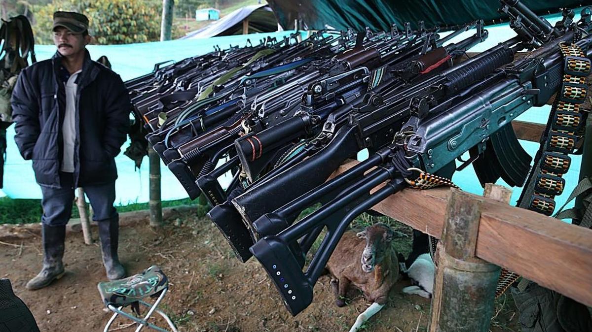 A FARC member guards several rifles at the transition zone in the town of Icononzo in the Tolima department.