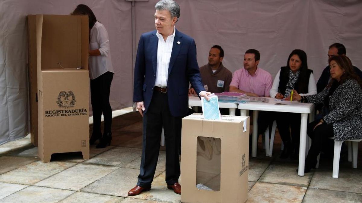 Colombia's President Juan Manuel Santos votes during local and regional elections in Bogota, Colombia, Sunday, Oct. 25, 2015. Colombians went to the polls to choose mayors, governors, city council and state legislators.