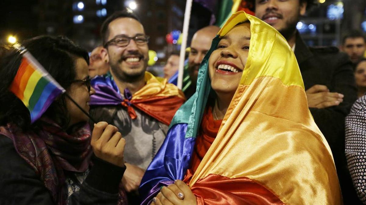 People celebrate in a park as they listen to the announcement from Havana, Cuba, that delegates of Colombia's government and leaders of the Revolutionary Armed Forces of Colombia reached a peace accord. The deal still must be ratified by voters.