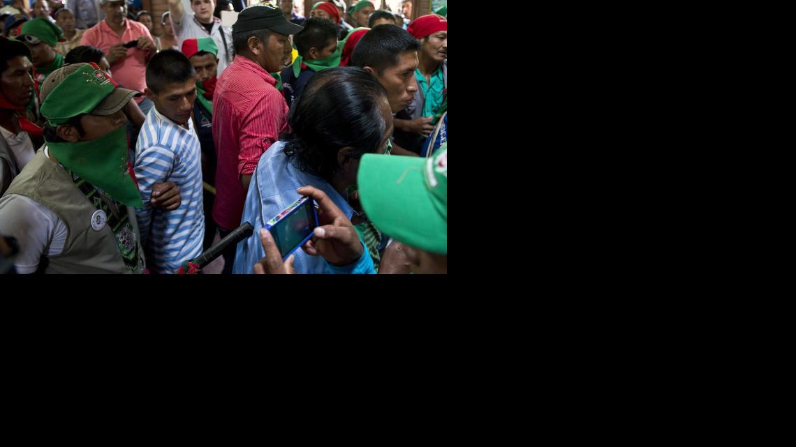 
Colombian Nasa native guards escort seven alleged FARC members accused of murdering two leaders of their tribe, just before the trial conducted by the tribe's leading authorities, on November 9, 2014, in Toribio, department of Cauca, Colombia. When crimes are committed in aboriginal territory, the punishment for the accused is decided by the community and not the ordinary justice system. The suspected Revolutionary Armed Forces of Colombia (FARC) rebel fighters on Wednesday attacked two native leaders who were removing billboards praising the late leader of the Revolutionary Armed Forces of Colombia, Guillermo Leon Saenz, also known as Alfonso Cano. 
