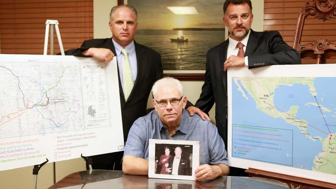 Antonio Caballero (front center) holds an image of his parents as his lawyers Joseph Zumpano (left) and Leon Patricios (right), who recently recovered assets related to a $191 million judgment against an array of actors including Colombia's FARC and Mexican cartels for Caballero on Wednesday, February 15, 2017.