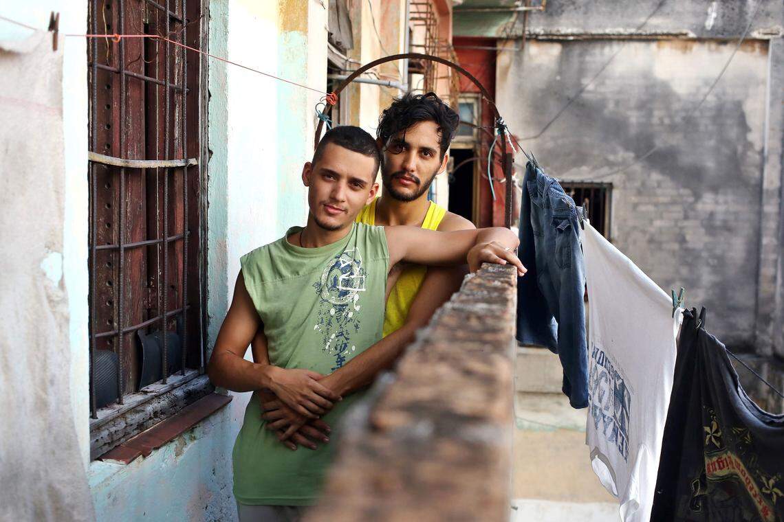Oscar Alejandro Pérez Enríquez, 20, left, and his partner, David Martínez García, 30, pose at their home in a popular neighborhood of Havana, Cuba.