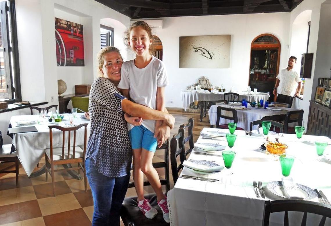 Niuris Higueras Martinez gives her daughter, Ysabella Cabeiro Higueras, a big hug at Higueras’ private Havana restaurant Atelier.