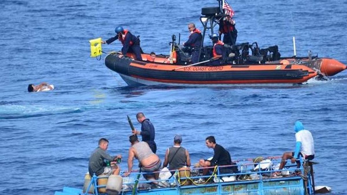 A crewmember of the Coast Guard cutter Mohawk passes a life jacket to a Cuban immigrant who had jumped into the water from a rickety boat intercepted south of Key West, in 2015.