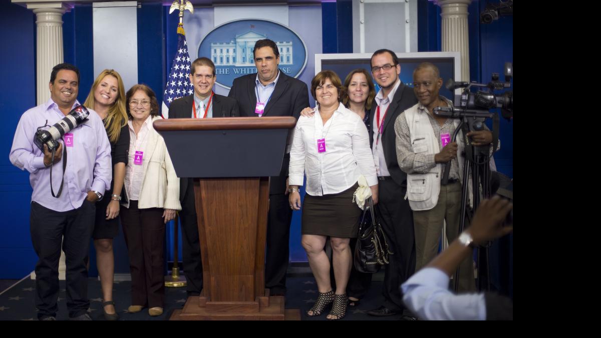 Cuban journalists pose for a group photo after attending the daily news briefing in the James Brady Press Briefing Room of the White House in Washington, Thursday, May 21, 2015. The group had visited the White House after covering the talks to re-establish diplomatic relations between the United States and Cuba, currently going on at the State Department. 
