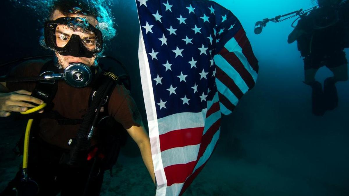 Navy Petty Officer 2nd Class Tyler Thompson, assigned to Expeditionary Combat Camera, conducts underwater photo training off the U.S. Navy base at Guantánamo Bay, Cuba, on Nov. 16, 2015 in this Pentagon handout photo.