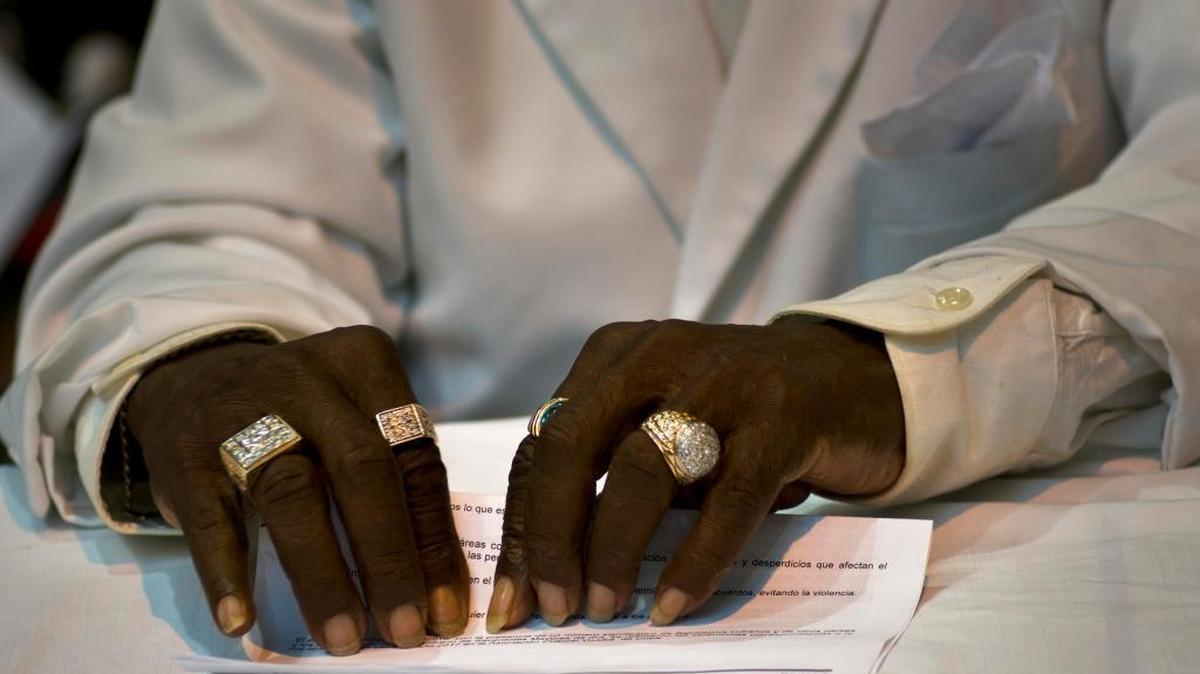 A babalawo in Havana holds the annual Letter of the Year, issued by Afro-Cuban priests, which outlines predictions for the new year.