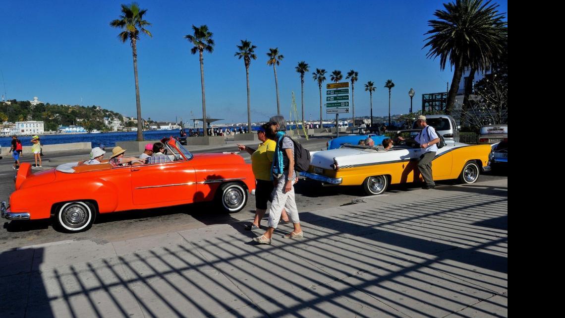 
Tourists from the United States are seen in old American cars in Havana, on April 6, 2015. 
