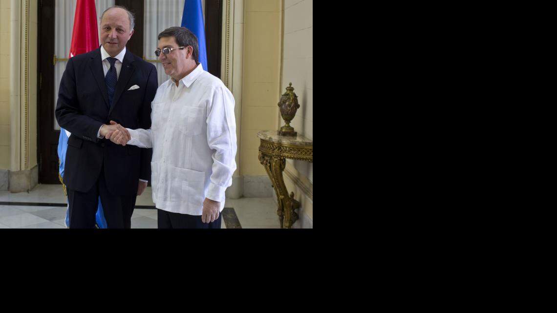 
Cuba's Foreign Minister Bruno Rodriguez, right, and France's Foreign Minister Laurent Fabius shake hands toward photographers prior to their meeting at the Foreign Ministry in Havana, Cuba, Saturday, April 12, 2014. France's foreign minister visited Cuba for the first time in 30 years at a time when the communist-led Caribbean nation is seeking to draw more foreign investment and improve ties with the European Union. 
