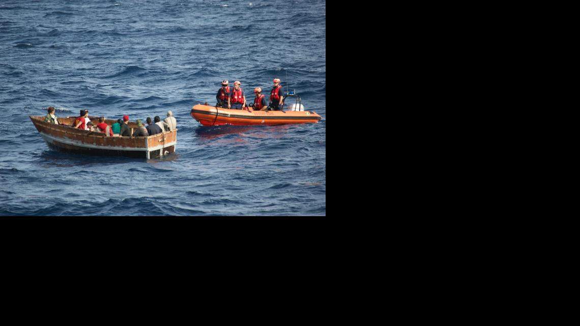 
A boatcrew with the Coast Guard Cutter Knight Island approach a rustic vessel southwest of Key West, Florida, Dec. 30., 2014. The rustic vessel had 12 Cuban migrants aboard who were later repatriated to Bahia de Cabañas Cuba, Jan. 5, 2015. 
