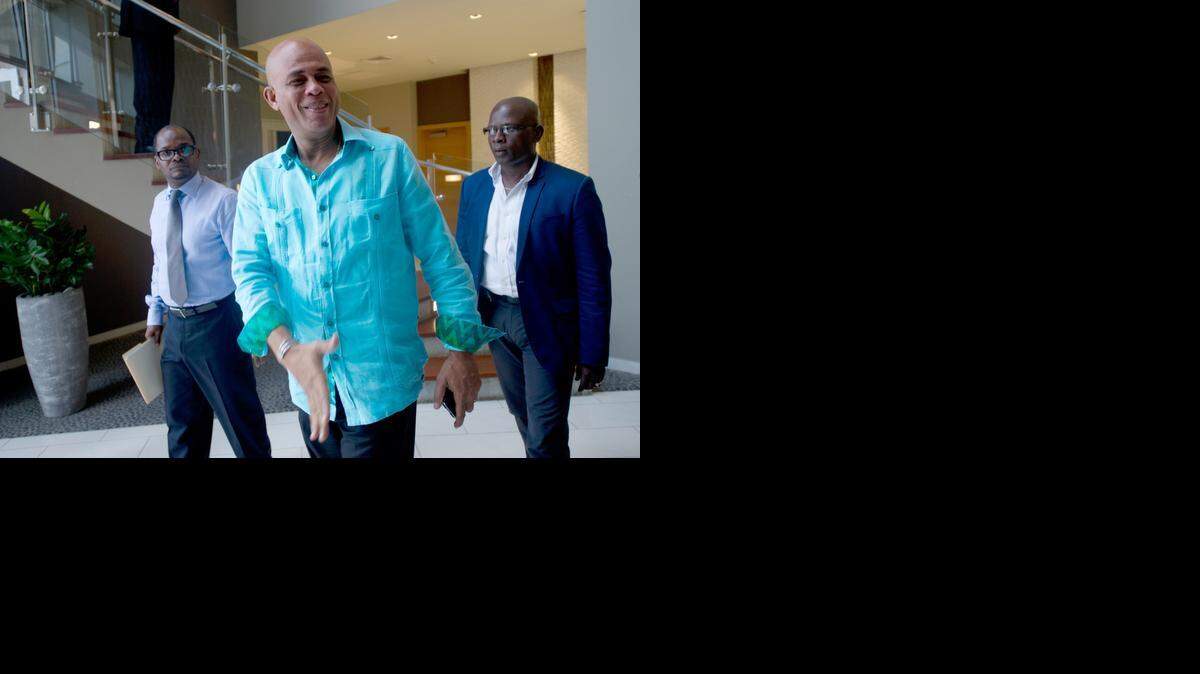 
Haitian President Michel Martelly departs following meetings with members of opposition parties Port-au-Prince. 
