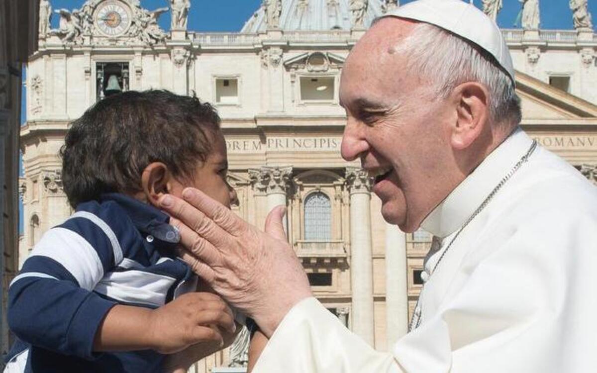 
Pope Francis caresses a child as he arrives for his weekly general audience, in St. Peter's Square, at the Vatican, Wednesday, April 22, 2015. 
