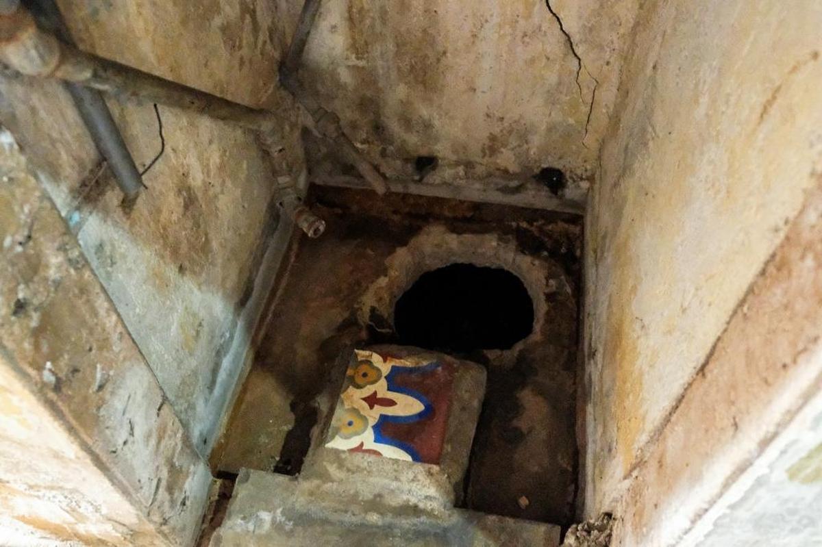 What family members call their well lies beneath cracked concrete in a damp, old cistern. The only way to reach it is by stooping into the cupboard-sized “room” and dipping a bucket into a dark hole.