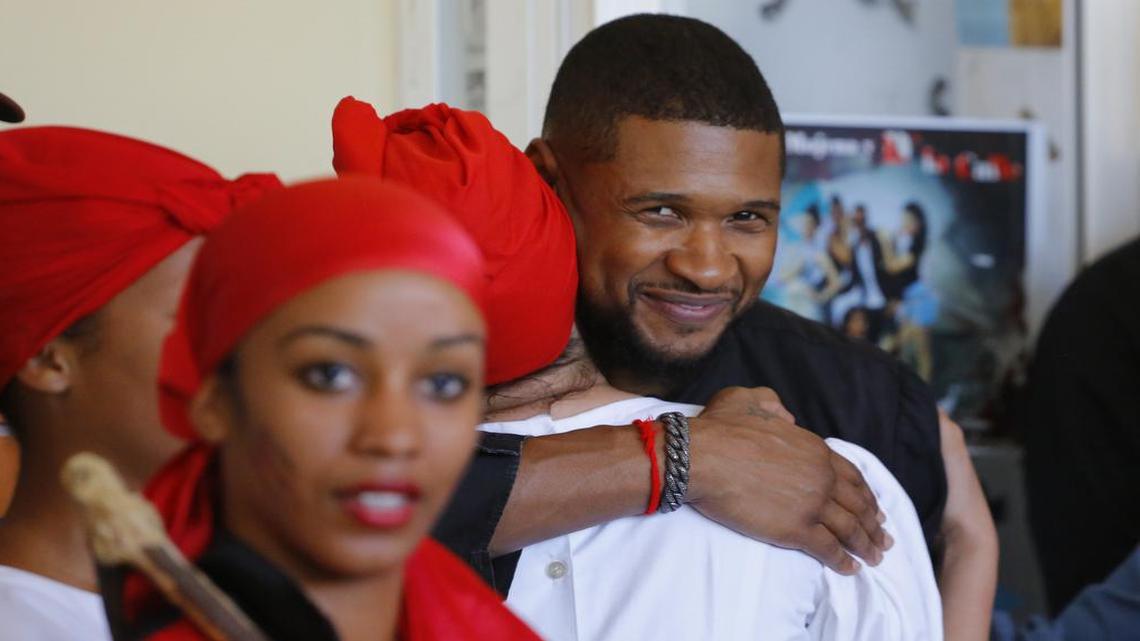 American artist Usher embraces an Afro-Cuban dancer after a performance at the Arts Institute in Havana. He was part of the delegation on a four-day cultural mission to Cuba.