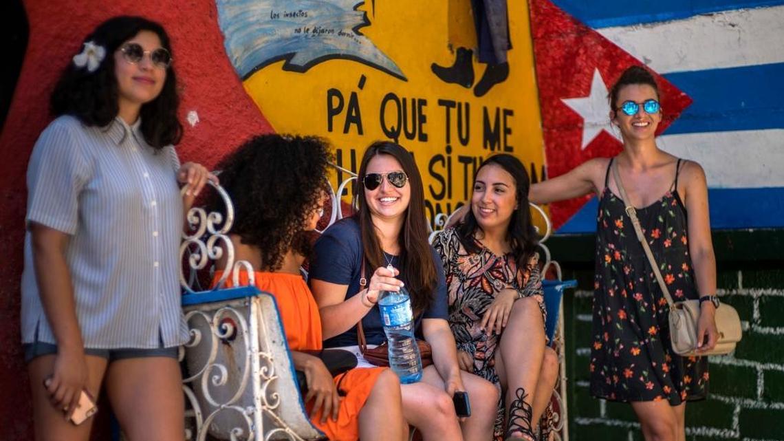 The children of Cubans living abroad will be able to apply for and obtain Cuban citizenship starting this week, without the need to live on the island for any length of time. In this June 12, 2016 photo, Cuban American Miranda Hernandez, center, talks with other youth who traveled with CubaOne program in Havana, Cuba.