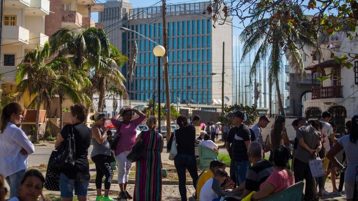 People wait to for visa applications outside the U.S. embassy in Havana, Cuba, Monday, Oct. 2, 2017. Thousands of Cubans have had their travel plans thrown into limbo by the U.S. government's announcement it has suspended visa processing in Havana. Some people picked up visas that had been approved prior to the announcement.