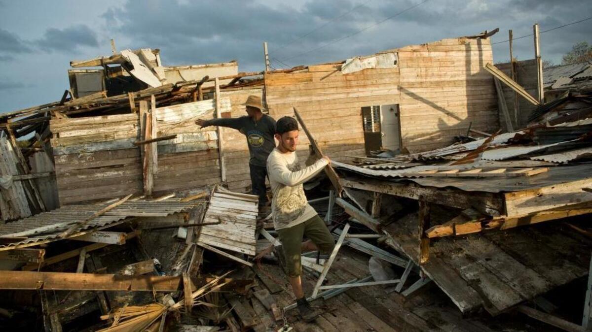 Affected by Hurricane Irma a man seek to save their belongings in their destroyed house in Isabela de Sagua, Cuba.