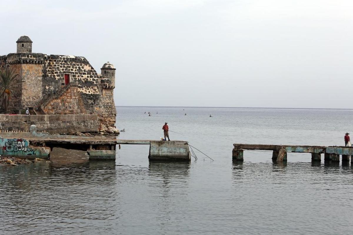 A man fishes off a pier in Cojímar that was partially destroyed during the outer bands of Hurricane Irma.