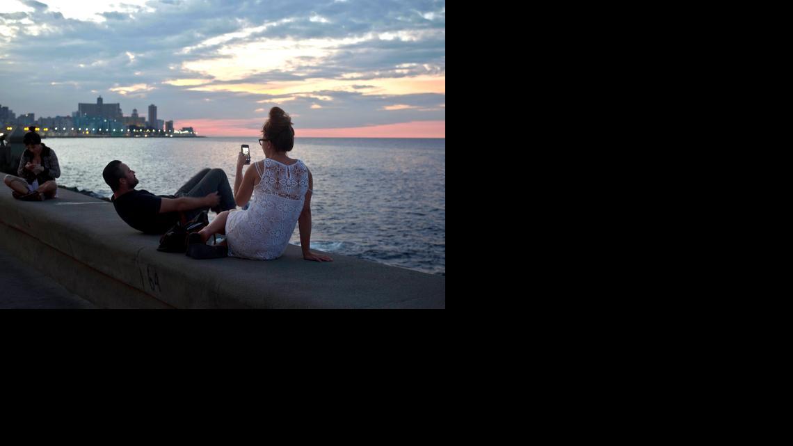 
Tourists enjoy taking photos at the Malecon in Havana, Cuba, Friday, Dec. 19, 2014. After a half-century of Cold War acrimony, the United States and Cuba abruptly moved on Wednesday to restore diplomatic relations, a historic shift that could revitalize the flow of money and people across the narrow waters that separate the two nations. 
