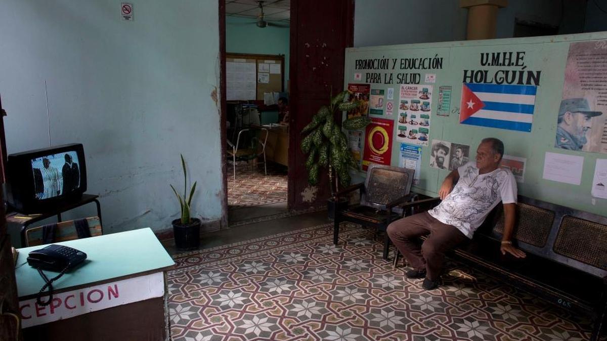 
A man watches the arrival airport ceremony for Pope Francis in the capital on a television set at a government office in Holguin, Cuba, Saturday, Sept. 19, 2015. 

