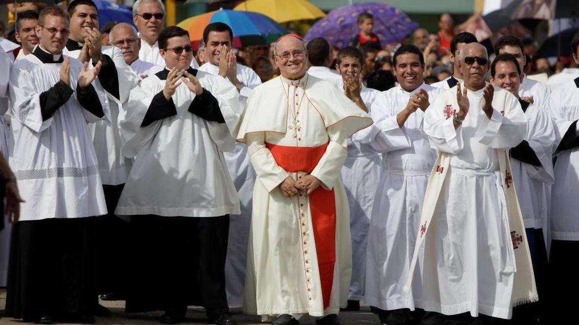 Cuba's Cardinal Jaime Ortega, center, smiles as he waits for the image of Our Lady of Charity of El Cobre, Cuba’s patroness, during a procession in Madruga, Cuba, in 2011. s