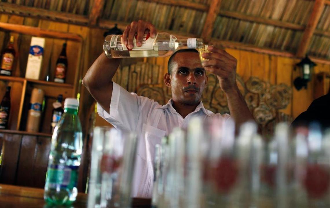 A bartender prepares a mixed drink in San Jose las Lajas, Cuba. The U.S. Treasury has clarified that although two Cuban rum brands on the U.S. prohibited list that seeks to keep money away from enterprises run by the Cuban military, travelers won’t have to query their bartenders about what rum they’re using in their drinks.