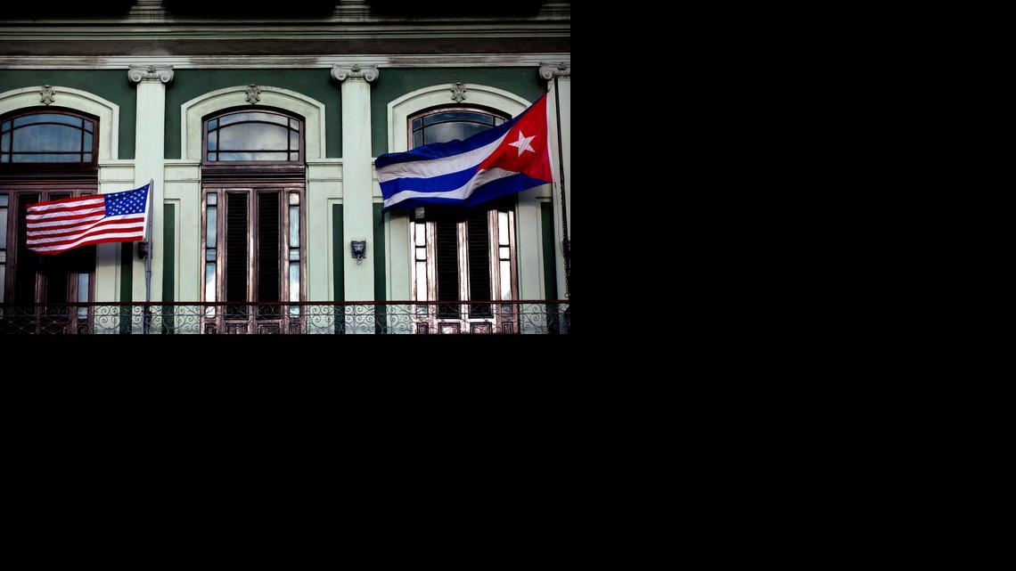 
In this Jan. 19, 2015 file photo, a Cuban and U.S. flag wave from the balcony of the Hotel Saratoga in Havana. The highest-level U.S. delegation to Cuba in decades kicked off two days of negotiations Wednesday after grand promises by President Barack Obama about change on the island and a somber warning from Cuba to abandon hopes of reforming the communist government. 
