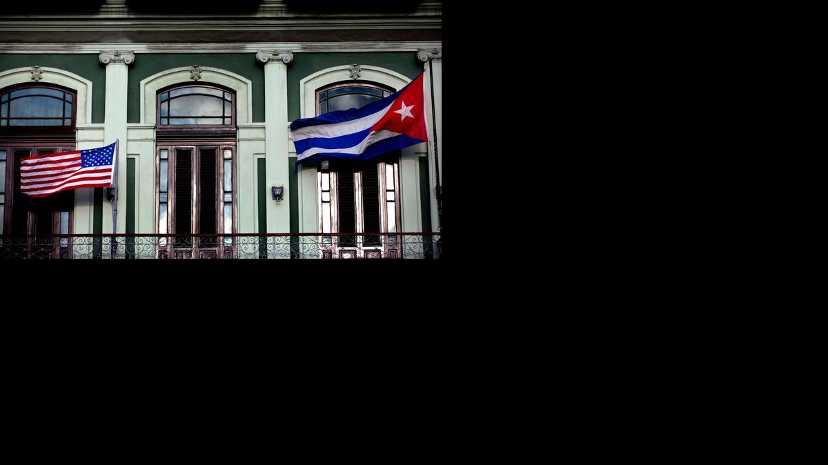 
In this Jan. 19, 2015 file photo, a Cuban and U.S. flag wave from the balcony of the Hotel Saratoga in Havana. The highest-level U.S. delegation to Cuba in decades kicked off two days of negotiations Wednesday after grand promises by President Barack Obama about change on the island and a somber warning from Cuba to abandon hopes of reforming the communist government. 
