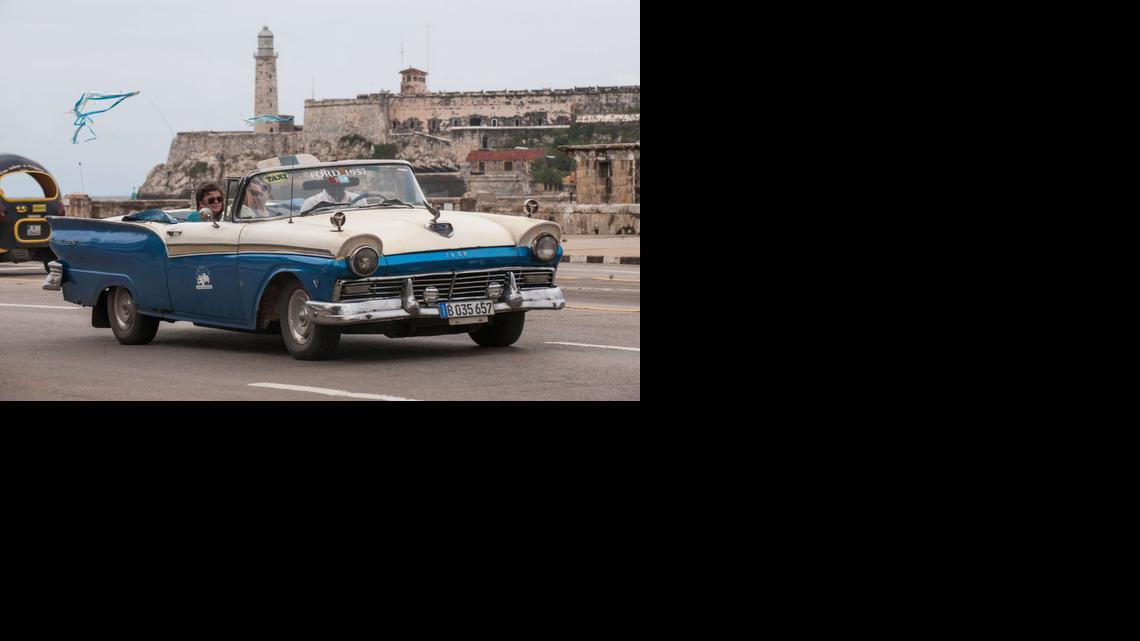 
(FILES) This January 8, 2014 file photo shows tourists as they travel in a taxi, in Havana. The United States will ease travel and trade restrictions with Cuba on January 16, 2015, implementing last month's agreement to begin normalizing ties with the Cold War-era foe.
