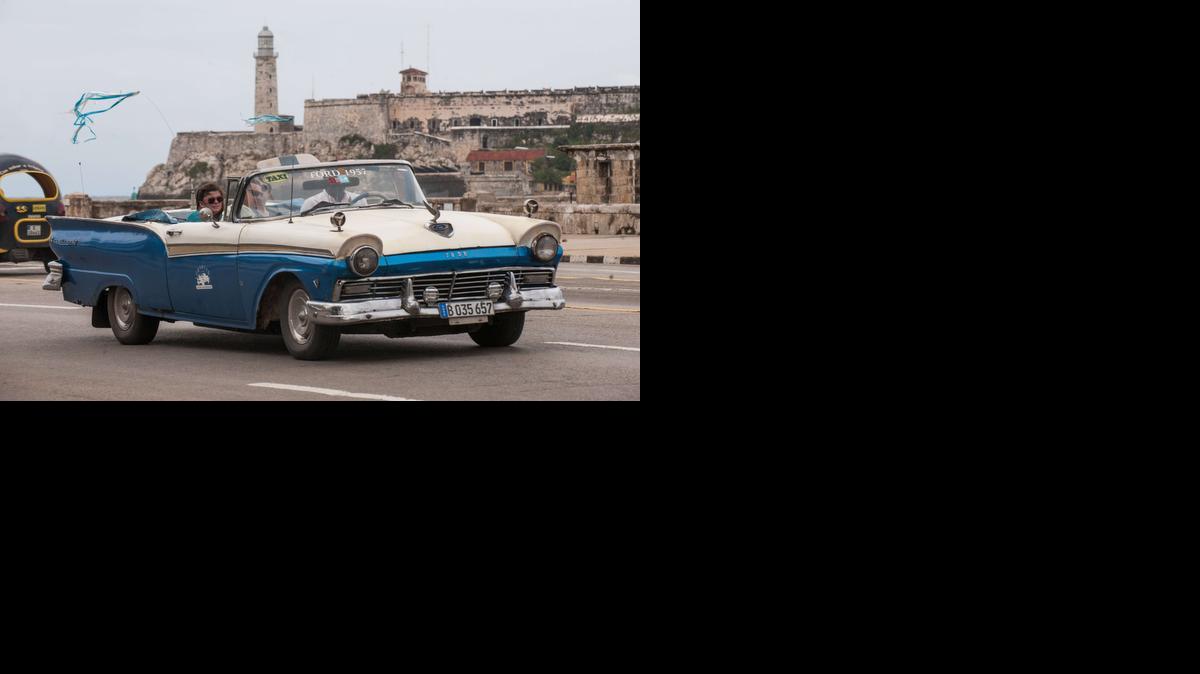 
(FILES) This January 8, 2014 file photo shows tourists as they travel in a taxi, in Havana. The United States will ease travel and trade restrictions with Cuba on January 16, 2015, implementing last month's agreement to begin normalizing ties with the Cold War-era foe.
