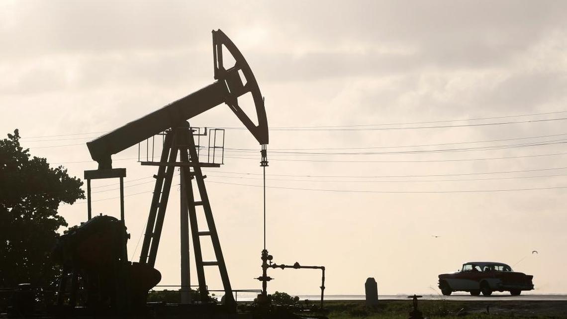 In this July 11, 2014 file photo, an oil well pump operates in Boca de Jaruco, Cuba. Officials are warning of tough times with authorities ordering energy-saving measures and some state entities reducing hours of operation.