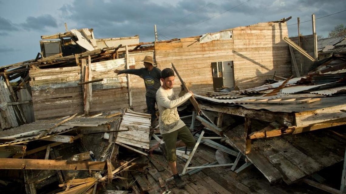 A man tries to save his belongings from a home destroyed by Hurricane Irma in Isabela de Sagua, Cuba, on Sept. 11, 2017. Four months after Category 5 Irma scraped Cuba, damaged housing remains a critical issue.