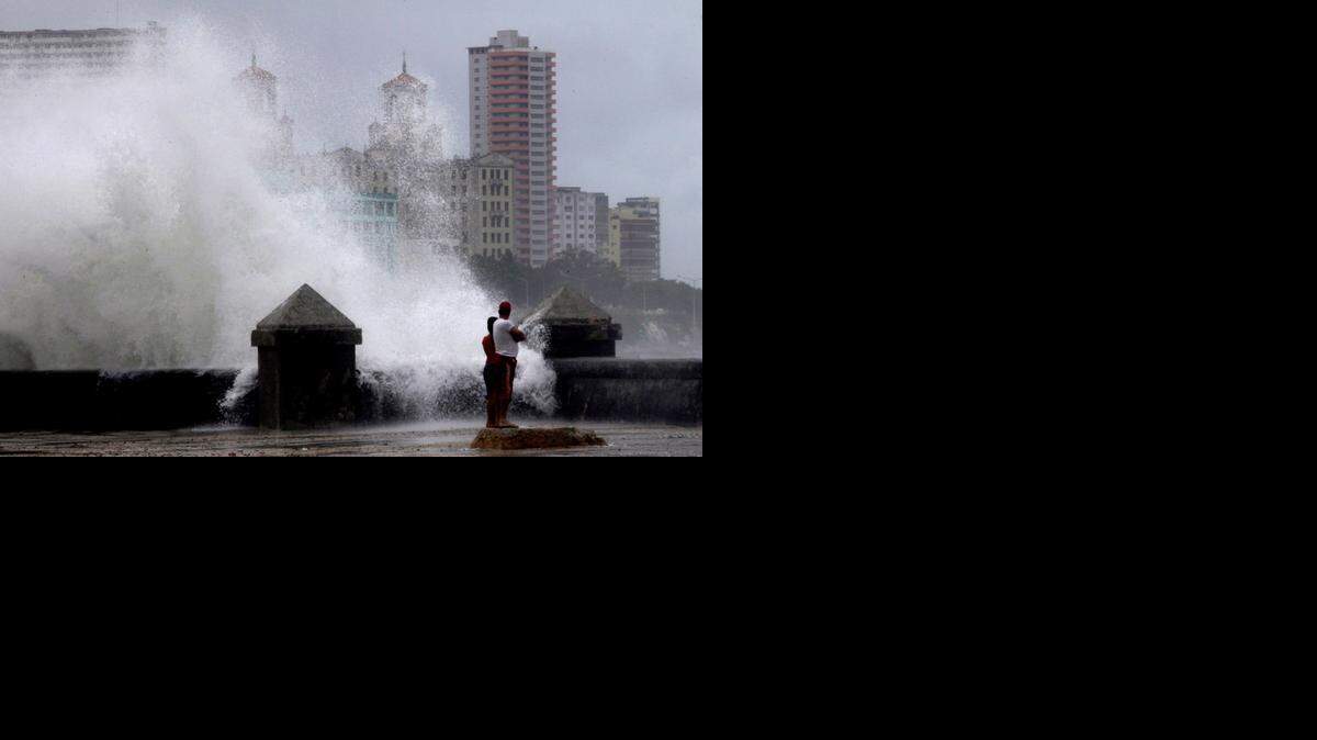 
Waves pound the boardwalk, the Malecon, during the passing of Tropical Storm Isaac in Havana Cuba, Sunday, Aug. 26, 2012. The hurricane center said the storm, which was swirling north of the central coast of Cuba in the pre-dawn hours, was expected to be near or over the Florida Keys sometime later Sunday or Sunday night. 

