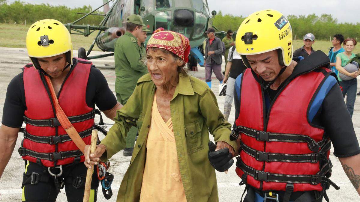 A woman is rescued in the province of Granma after Hurricane Melissa left many residents trapped by flooding.