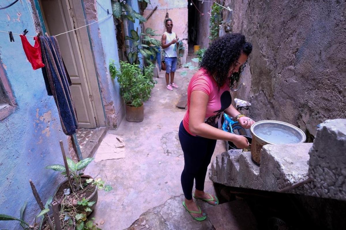 The lava-hot water pot will sit on the steps to cool for another 2 to 3 hours. In that time, Elena Rodriguez will start dinner. She will wash beans, tomatoes and onions in well water. Then hope any impurities will cook away.