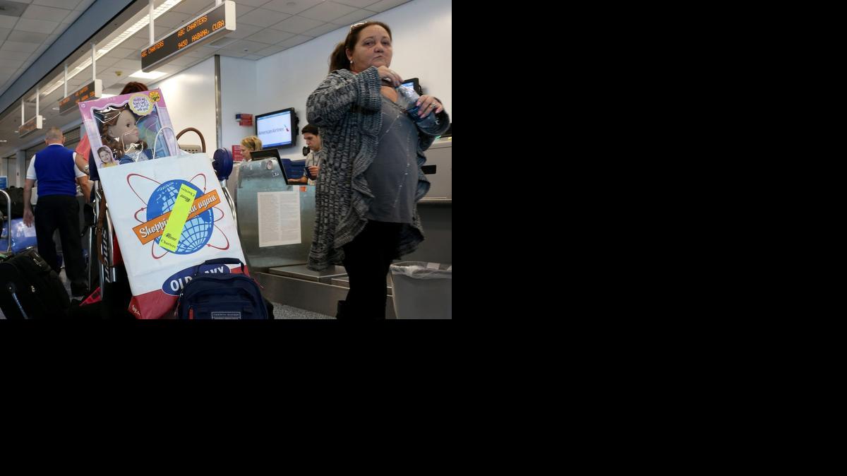
People wait in line to check luggage at the ABC Charters American Airlines flight to Havana at Miami International Airport last month.
