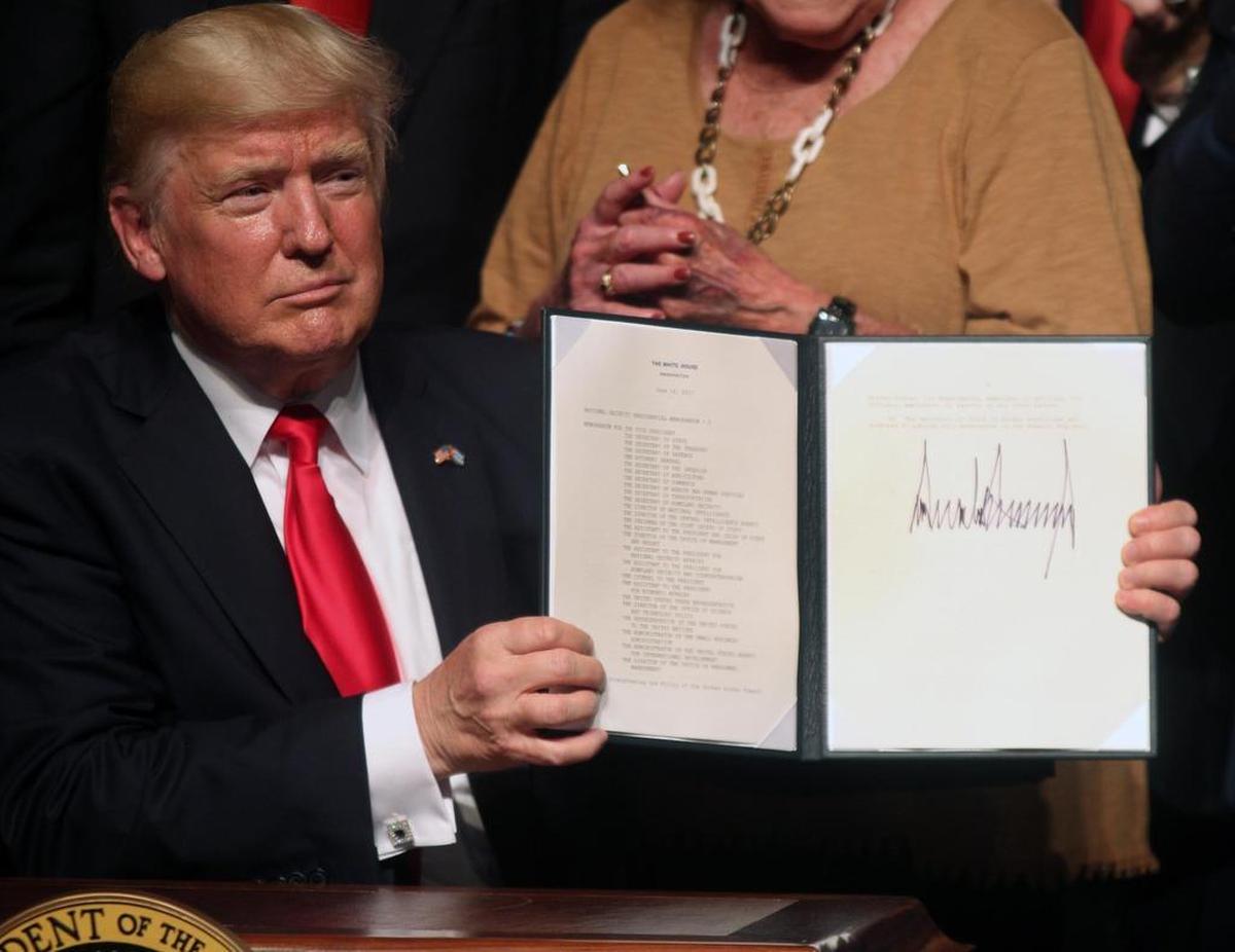 President Donald Trump signs his new Cuba policy Friday, June 16, 2017, at the Manuel Artime Theater in Miami.