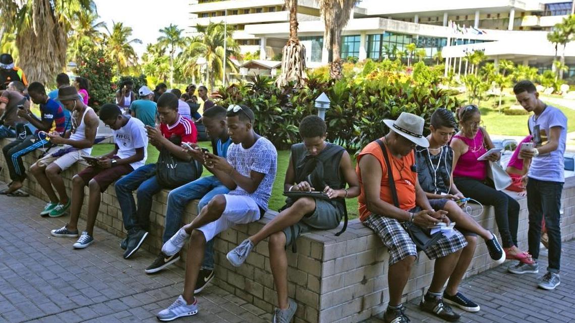 
Below, Cubans gather at a hotspot in Playa by the ETECSA office to receive open Wi-Fi service in Havana on Sept. 19. Since July, the Cuban government has rolled out 35 new Wi-Fi hotspots. They’ve proved popular.


