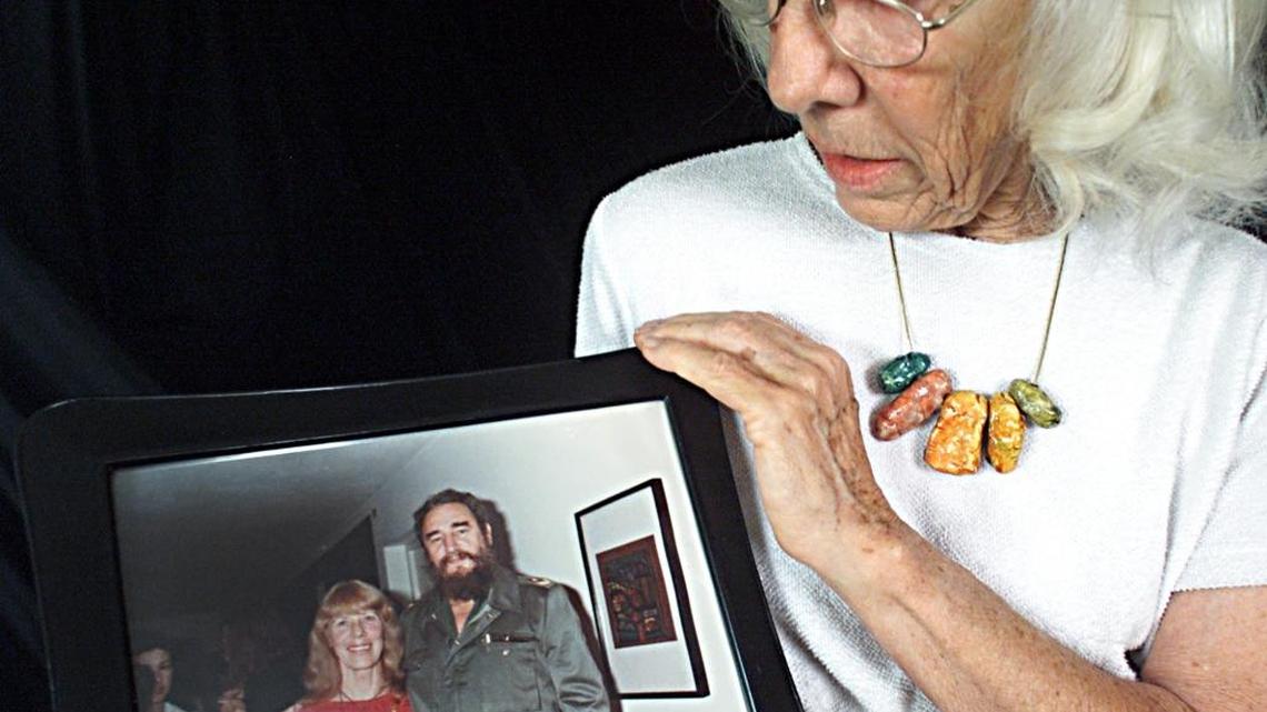 In this 2001 file photo, Lorna Burdsall, then 70, poses with an old photo of herself with Cuban leader Fidel Castro, at her home in Havana, Cuba.