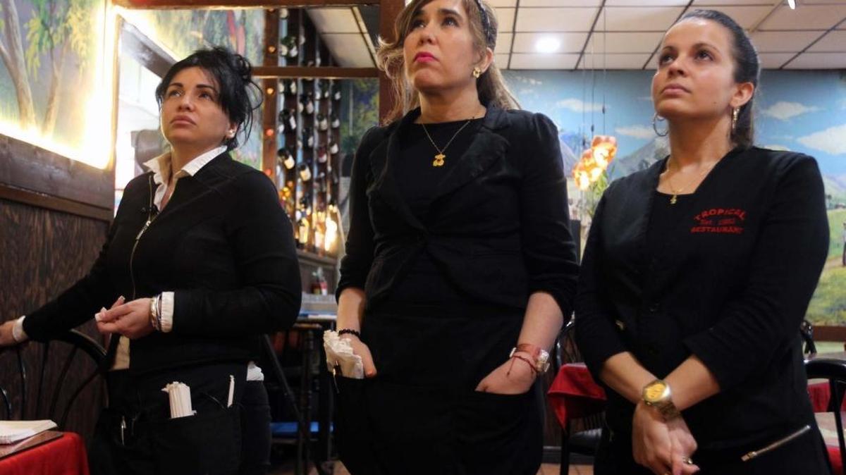 Mabel Abreu, Yudith Arronte and Yuleidis Calbó, waitresses at Tropical Restaurant in Hialeah, watch President Obama’s speech from Havana on Tuesday