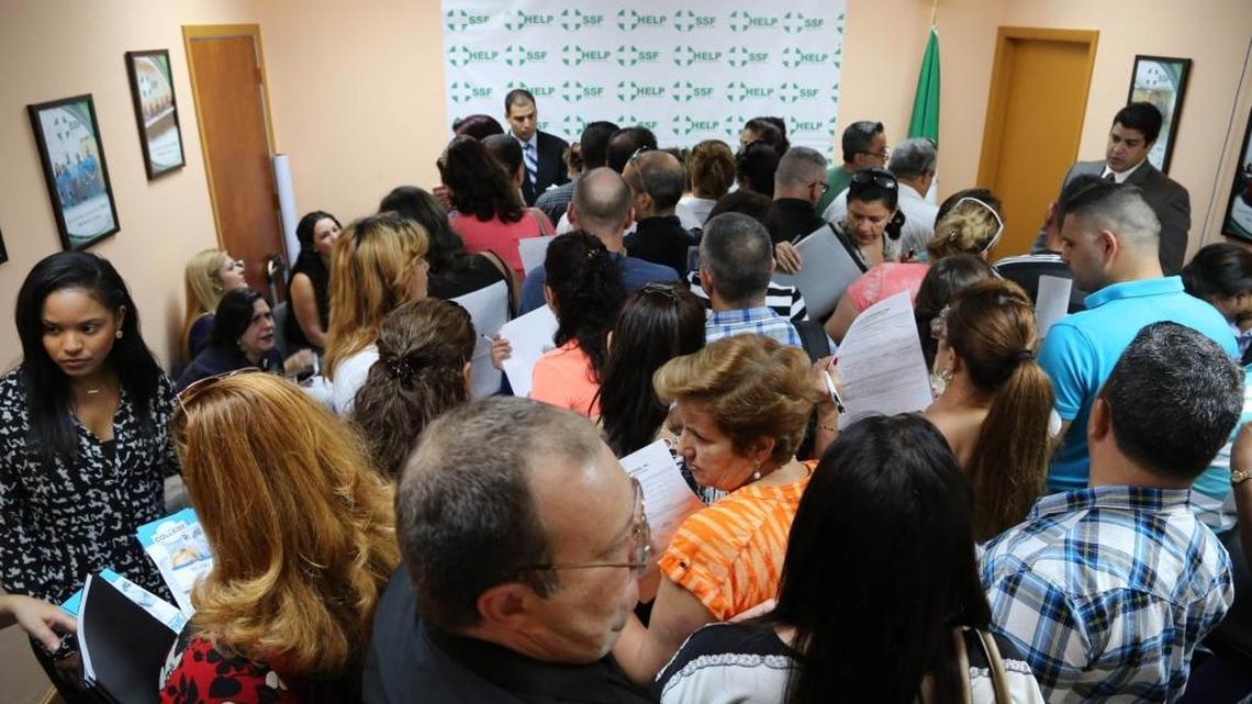 Hundreds of health professionals gather at a job fair hosted by Solidarity Without Borders in Hialeah in 2014. Thousands of Florida immigrant doctors are seeking to re-enter their workforce.
