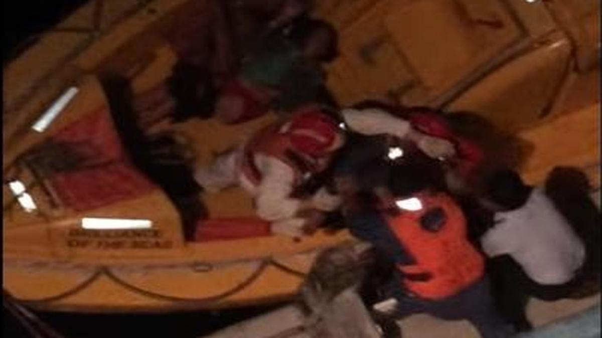 A screengrab from a YouTube video reportedly taken on the Brilliance of the Seas Friday, March 18, 2016 shows crews members helping to rescue Cuban rafters.