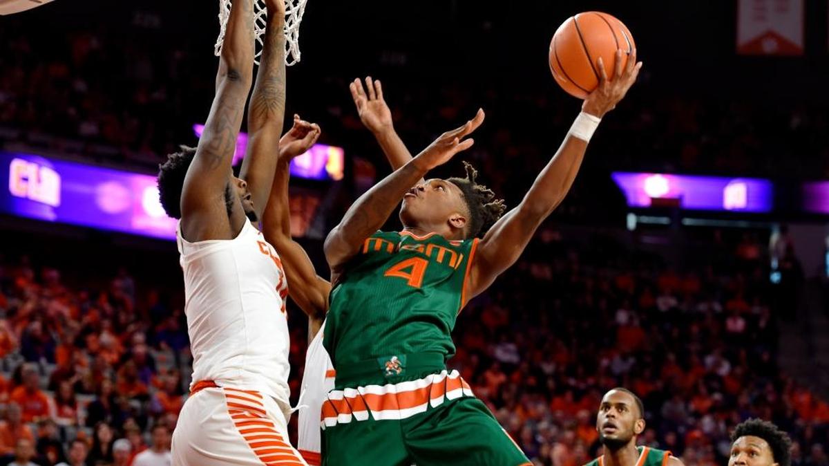 Miami's Lonnie Walker IV drives to the basket while defended by Clemson's Elijah Thomas during the first half of an NCAA college basketball game Saturday, Jan. 13, 2018, in Clemson, S.C.