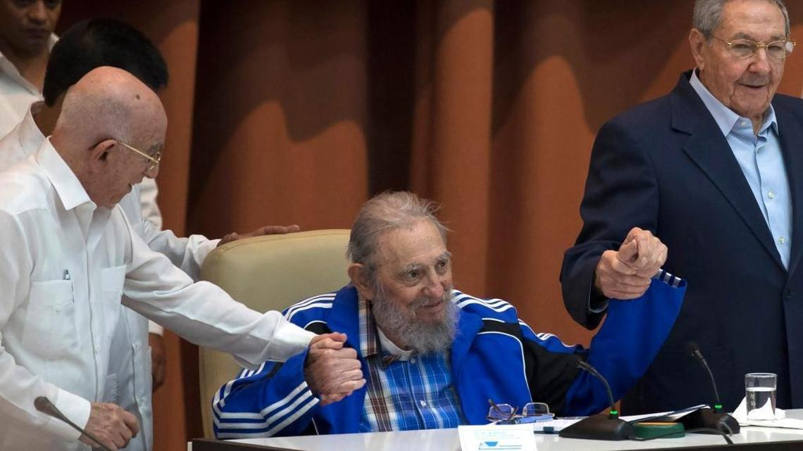 Fidel Castro clasps hands with his brother, Cuban leader Raul Castro, right, and second secretary of the Central Committee Jose Ramon Machado Ventura moments before the playing of the Communist party hymn during the closing ceremonies of the 7th Congress of the Cuban Communist Party, in Havana, Cuba, Tuesday, April 19, 2016.