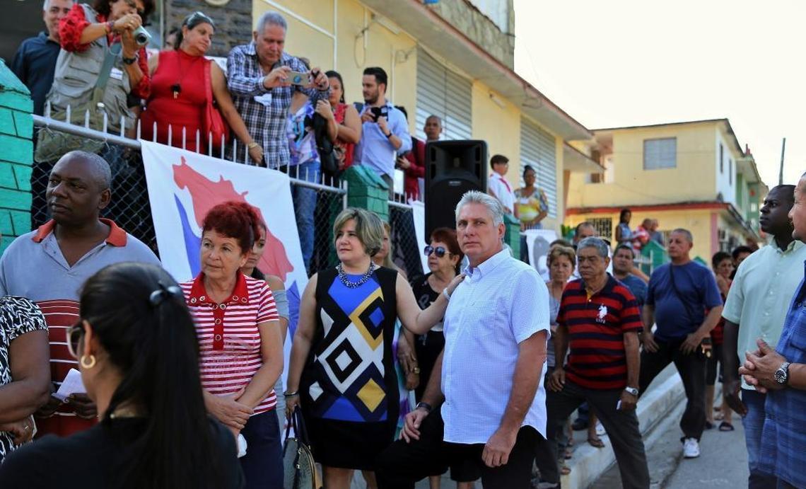 Cuba's Vice President Miguel Díaz-Canel, center right, and his wife, Liz Cuesta Peraza, wait in line at a voting center during elections for national and provincial representatives for the National Assembly in Santa Clara, Cuba, Sunday, March 11, 2018.