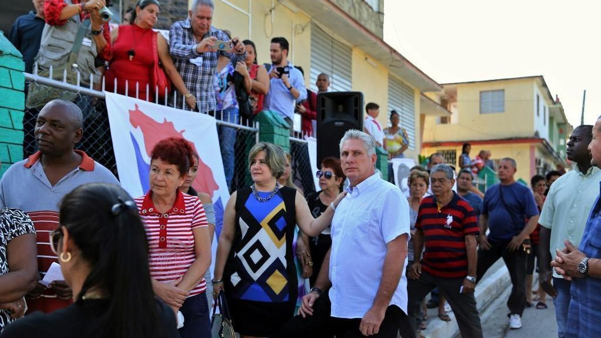 Cuba's Vice President Miguel Díaz-Canel, center right, and his wife, Liz Cuesta Peraza, wait in line at a voting center during elections for national and provincial representatives for the National Assembly in Santa Clara, Cuba, Sunday, March 11, 2018.
