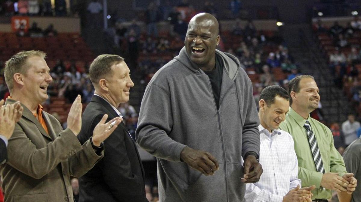 Former NBA star Shaquille O'Neal laughs with his former high school teammates during halftime of the boys' UIL Class 1A Division 1 state basketball final, Saturday, March 8, 2014, in Austin, Texas. O’Neal will travel to Cuba in June as part of a new sports envoy program with the U.S.