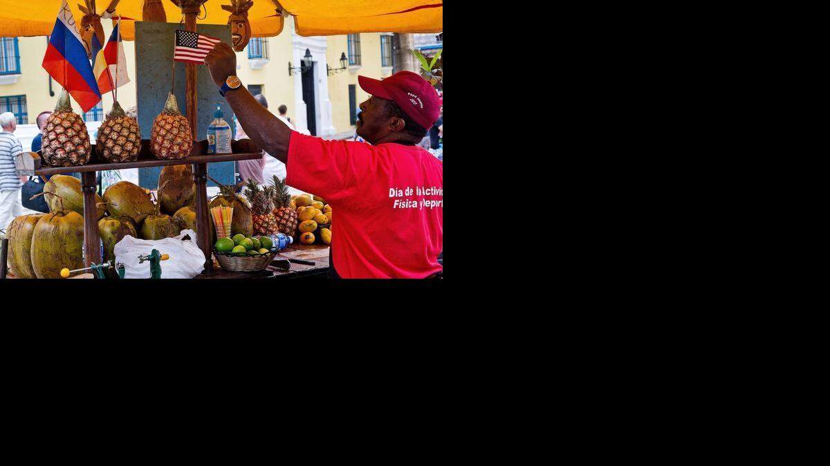 
A private fruit vendor decorates his stand with a U.S. flag in Havana.
